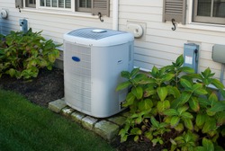 Heating and air conditioning inverter on the side of a house
