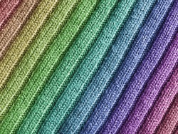 Close-up view of wool fabric pattern with rainbow coulors.