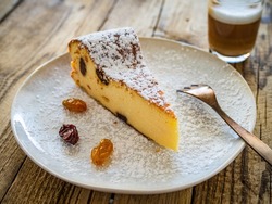 Cheesecake with raisins on wooden table