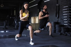 Attractive sport couple doing fitness at gym.