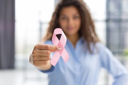 October breast cancer awareness month, woman with hand holding pink ribbon for supporting people living and illness. Healthcare, world cancer day concept
