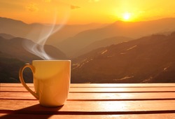 Morning cup of coffee with mountain background at sunrise