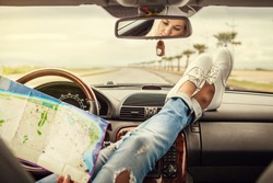 Young woman alone car traveler with map 