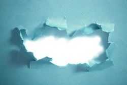 Hole in blue paper, abstract background