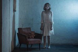 scary girl in white dress from horror film in  room