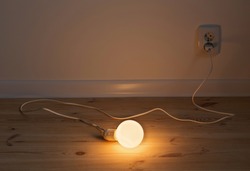 Light bulb lamp on wooden floor