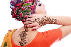 Beautiful woman arabian make up and turban on head with detail of henna being applied to hand and backt isolated 