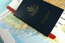 Australian passport, with flight boarding pass, on map of USA west coast