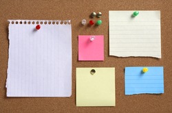 Various colorful blank notes on cork board