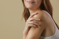 Woman applying body cream on arm, beauty skin care concept, studio shot