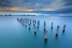 Twilight at concrete pillar in the sea at Pattaya,Thailand