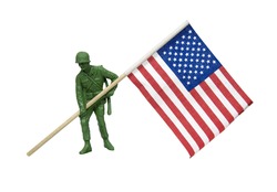 Soldier as represented by a green plastic model carrying an American flag