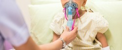 Nurse treat admitted patient boy by inhalation therapy with mask of inhaler. Sick little kid with RSV ,Respiratory Syncytial Virus, problem with oxygen mask breathes through nebulizer at hospital.