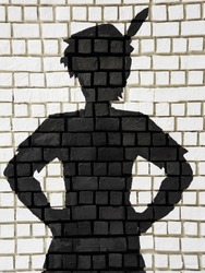 Painted silhouette black Peter Pan on white brick wall, Public decoration with free copy space for text or background usage. 