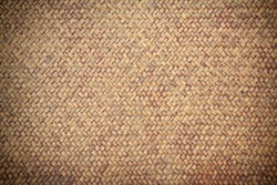 Old brown rattan weave wicker for textured background. Closeup pattern of traditional Thai handmade basket or tray.