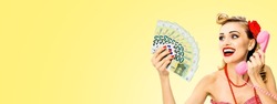 Happy smiling woman with money, euro banknotes talking on phone, in pin up style, on light yellow background. Blond girl in retro fashion and vintage sales, rebates discounts offers cash back cashback