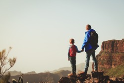 father and son hiking in scenic mountains