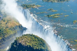 The Victoria falls is the largest curtain of water in the world (1708 m wide). The falls and the surrounding area is the National Parks and World Heritage Site (helicopter view) - Zambia, Zimbabwe