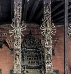 Carved wooden pillars with sculptures of the ancient temple at the 9 th century building - Bhaktapur, Nepal