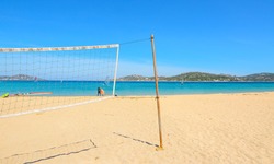 beach volley net and surfboards in Porto Pollo beach, Sardinia