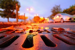close up of a drainage sewer at sunset