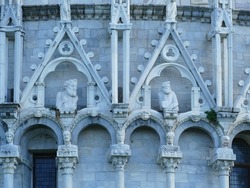 Gothic baptistry building in central piazza of Pisa, Italy