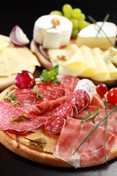 Salami and cheese platter with vegetable and herbs