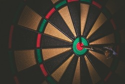 Business concept - Target and goal as concept. Dart arrow hit on bulleyes of dartboard to represent that the business reached the target