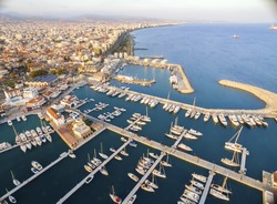 Aerial view of the beautiful Marina in Limassol city in Cyprus,beach,boats,piers,villas, commercial area,old port (palio limani) and Molos. A modern,high end,newly developed space with docked yachts. 