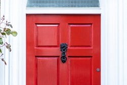Victorian door knocker on a rd wooden front door in England
