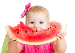 Child girl eating watermelon isolated on white background