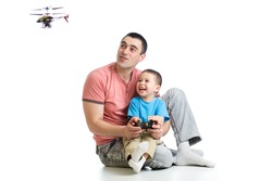 Father and son playing with RC helicopter toy