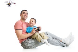 Child boy and dad playing with RC helicopter toy