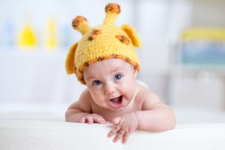 happy baby or child in giraffe costume 