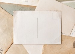 Vintage postcard on old grunge paper and envelopes background. Vintage background from old post cards.  