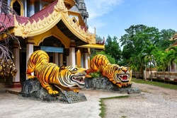 Statues of tigers at entrance to buddhist pagoda Tham Sua near Tiger Cave Temple in Krabi, Thailand. Two tiger sculptures at the entrance to the Thai traditional temple in Krabi.