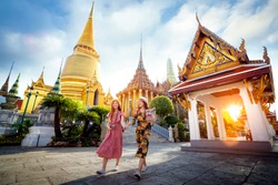 Asian girl walk in Wat phra kaew and grand palace travel in Bangkok city, Thailand