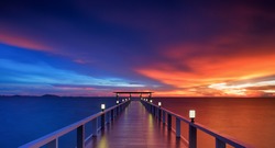 Wooded bridge in the beach island portalong the sunrise time.