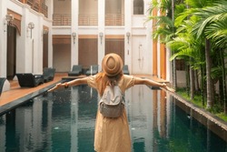 Asian woman traveller relax in resort and swimming pool in Hotel in Chiangmai, Thailand