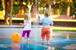 Little Girl and Boy Having Fun with the Water