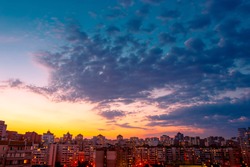 Beautiful sunset sky over city. Twilight over urban district. Aerial view. Typical modern residential area. Kyiv. Ukraine.