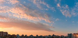 Beautiful sunset sky over city. Twilight over urban district. Aerial view. Typical modern residential area. Kyiv. Ukraine. Wide panorama.