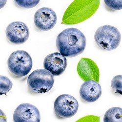 Seamless pattern of ripe blueberries with leaves on white background.