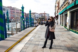 Mid adult Woman Tourist Photographing City Of Venice in Italy
