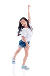 Young asian girl dancing and smiles over white background