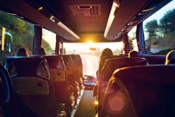 View from inside a stage coach Bus into the sunset - Bus interior trip with a bokeh back light front screen