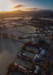 Aerial view photography of winter morning in countryside with frozen fields, houses in Blessington, Ireland