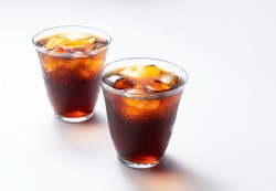 Cold coffee in a glass on a white background with space