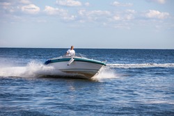 Man driving a fast boat 