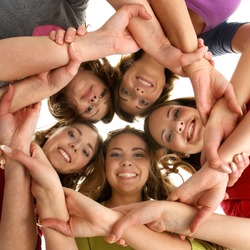 Group of smiling teenagers staying together and looking at camera isolated on white